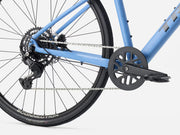 Close-up of a  blue hybrid fintess bicycle's gear system on a white background