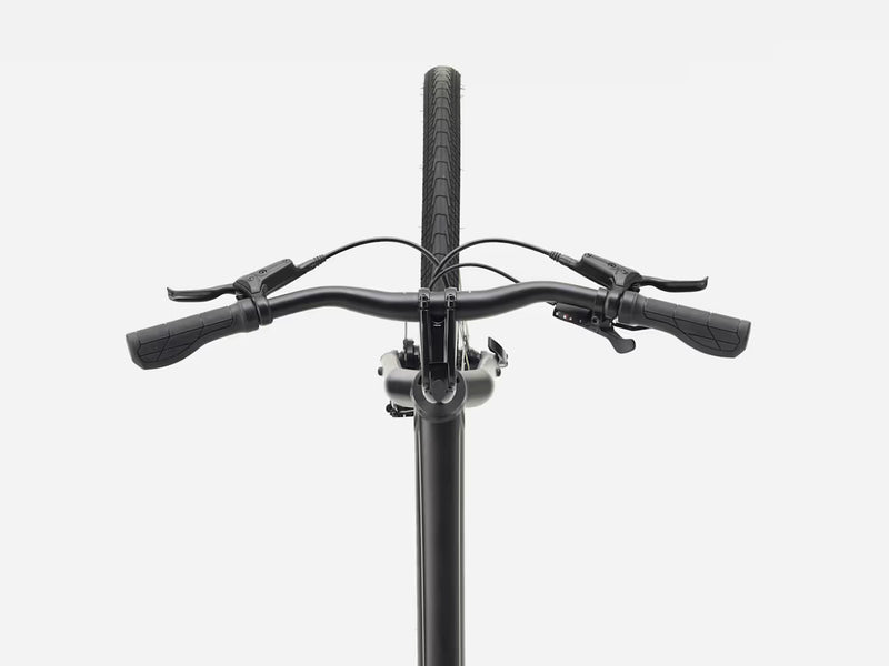 Close-up of a bicycle handlebar with black grips, brake levers, and a black stem against a light gray background.