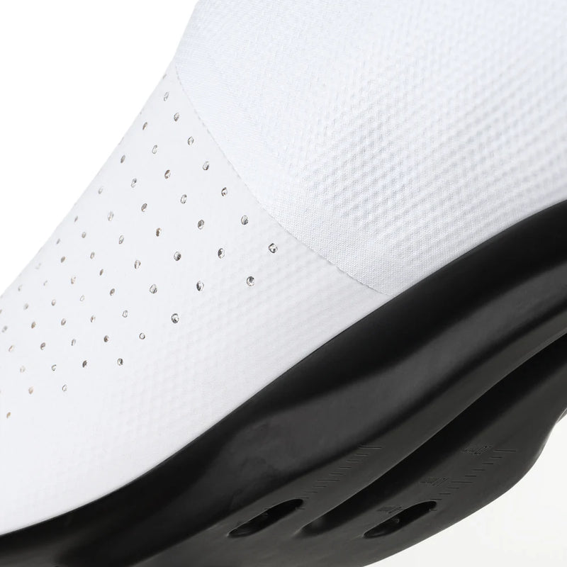 Close-up of a white sneaker with black sole on a white background