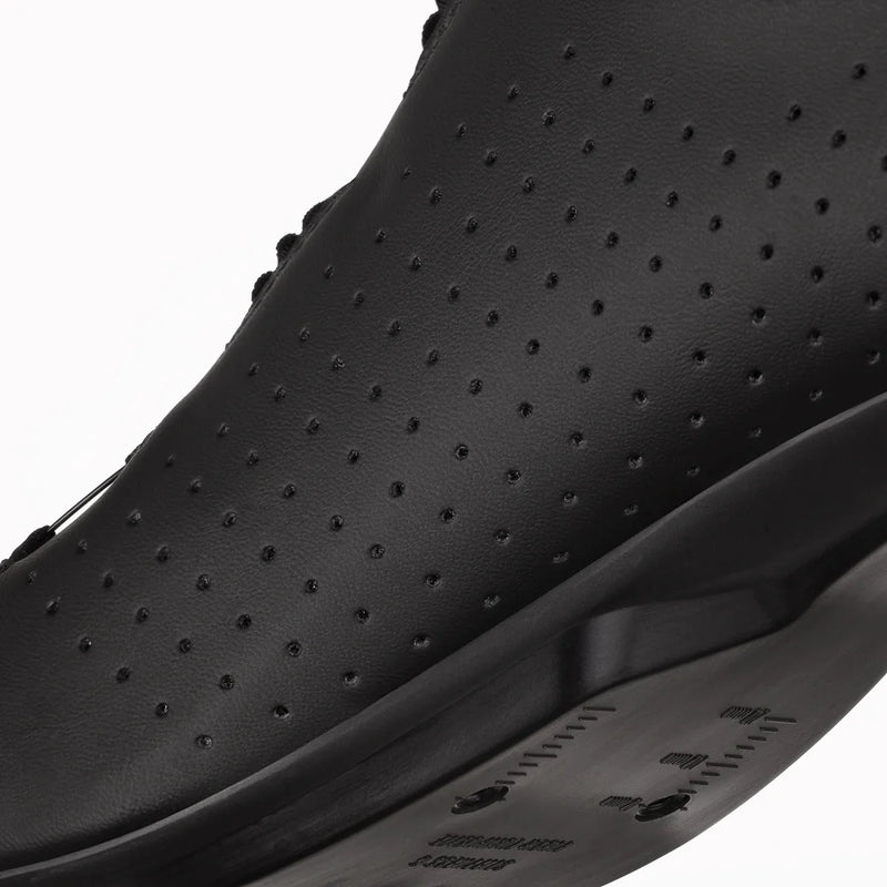 Black perforated shoe on a white background