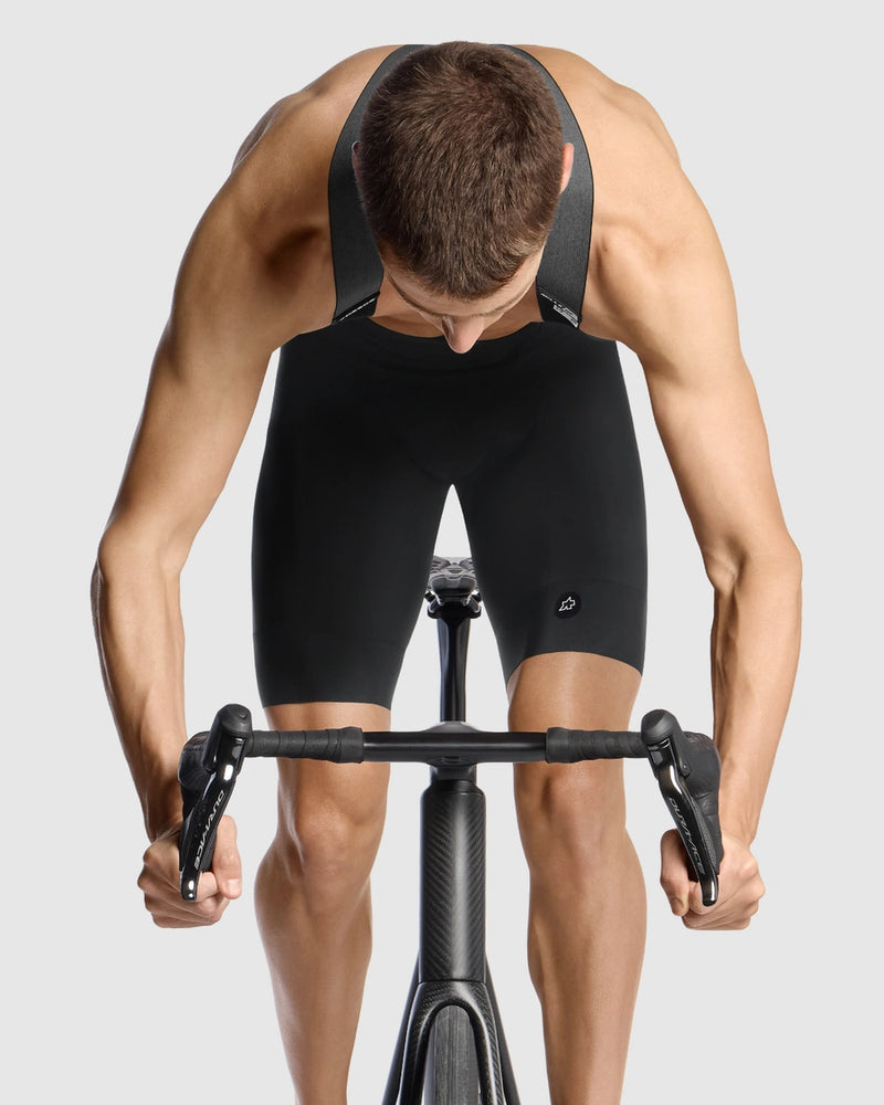 Person wearing a black cycling outfit on a white background