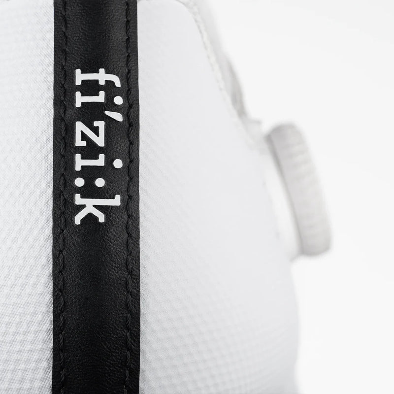 Close-up of a white cycling jersey with 'fi'zi:k' branding on a black stripe.