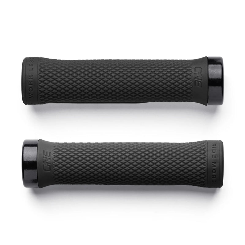Two black bicycle grips with textured surface on a white background