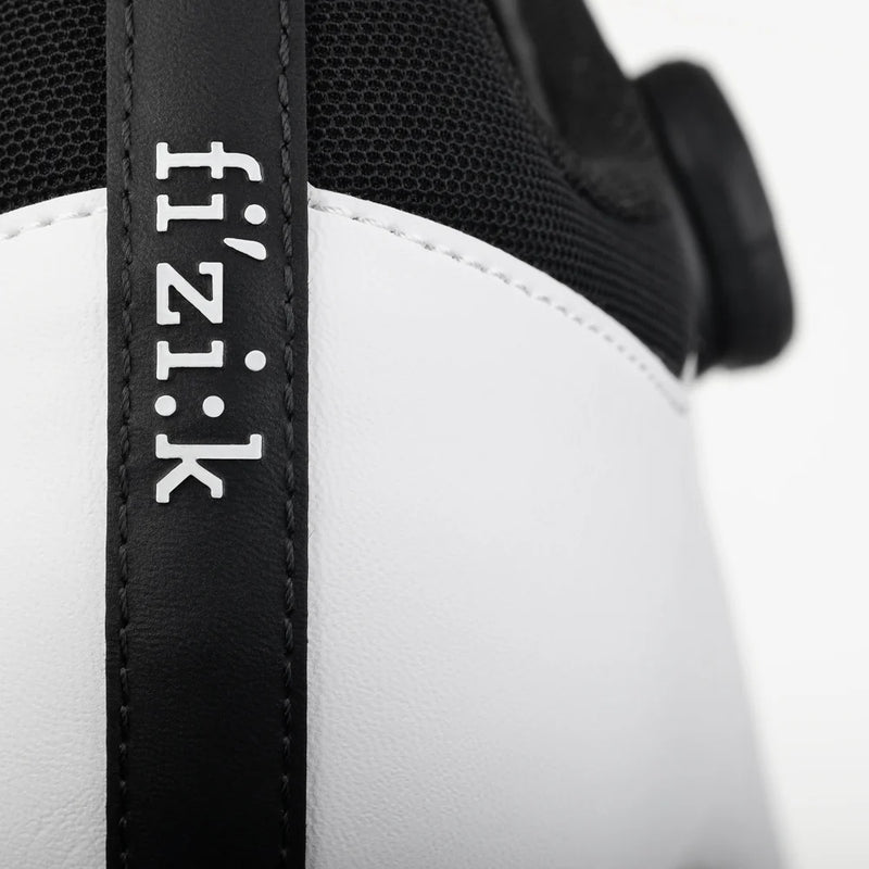 Close-up of a black and white cycling shoe with 'fizik' branding.