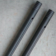 Two metallic cylindrical objects on a textured surface