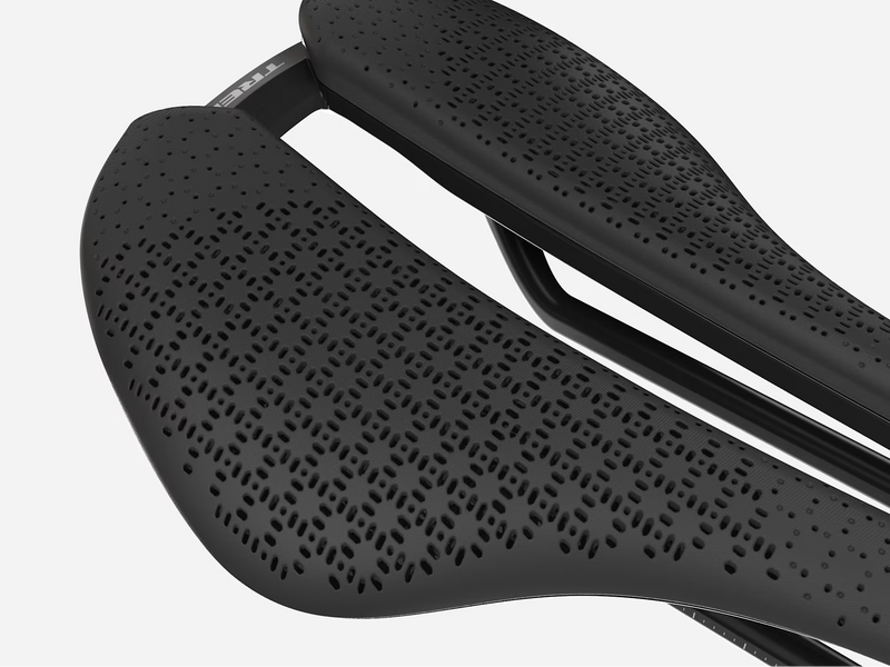 Close-up of a black bicycle saddle with textured surface on a white background