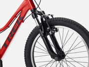 Close-up of a red bicycle with a black tire on a white background
