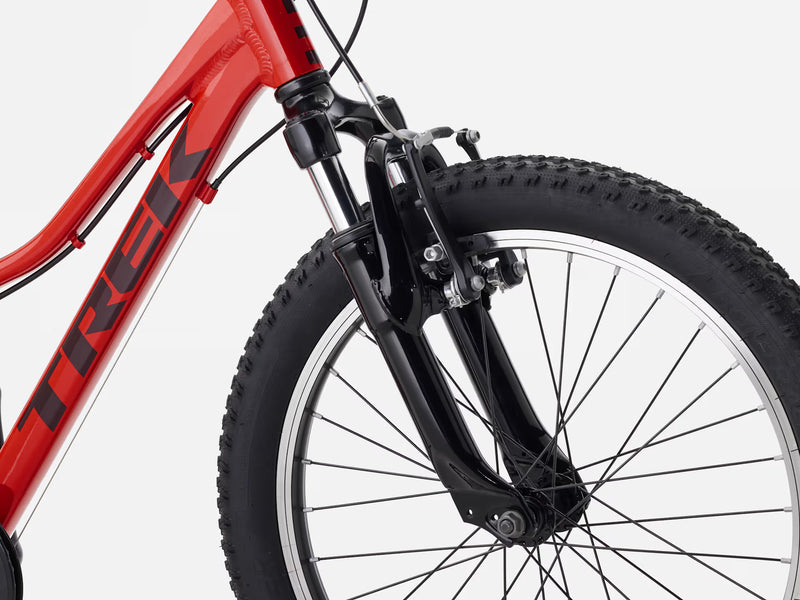 Close-up of a red bicycle with a black tire on a white background