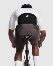 Person wearing a black cycling bib on a white background