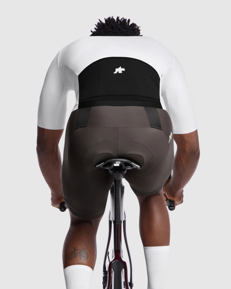 Person wearing a black cycling bib on a white background