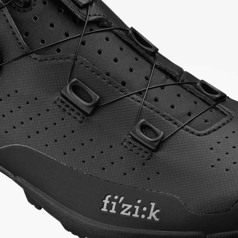 Close-up of a black cycling shoe with 'fizik' branding on a white background