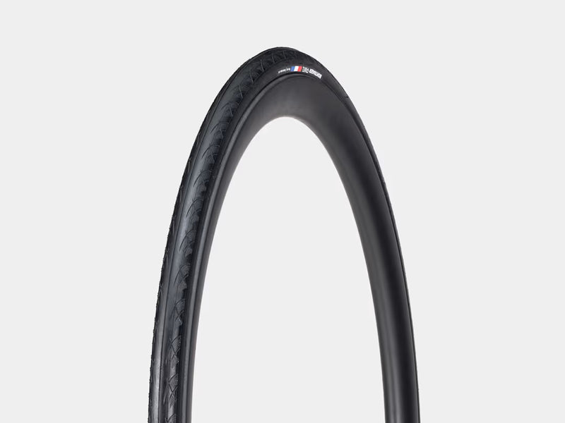 Black bicycle tire with a brand logo on a light gray background