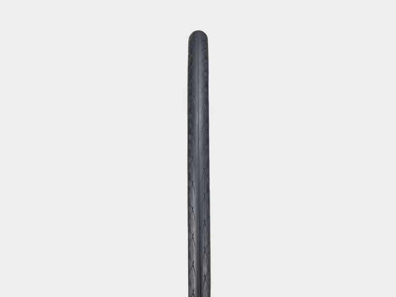 Black bicycle tire on a light gray background