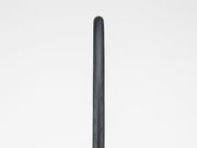 Black bicycle tire on a light gray background