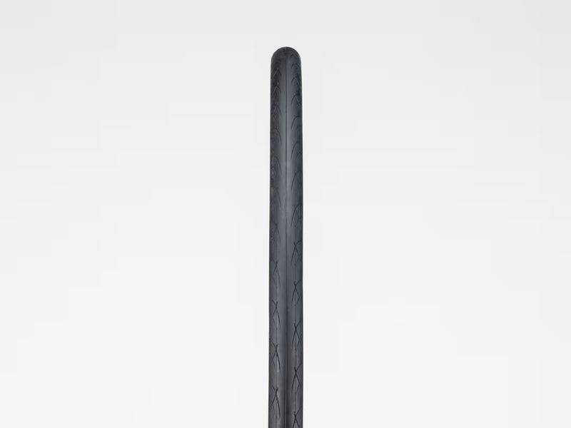 Black bicycle tire on a light gray background