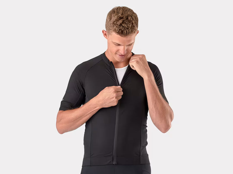 Man wearing a black athletic outfit on a white background