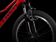 Close-up of a red Trek bicycle wheel on a black background