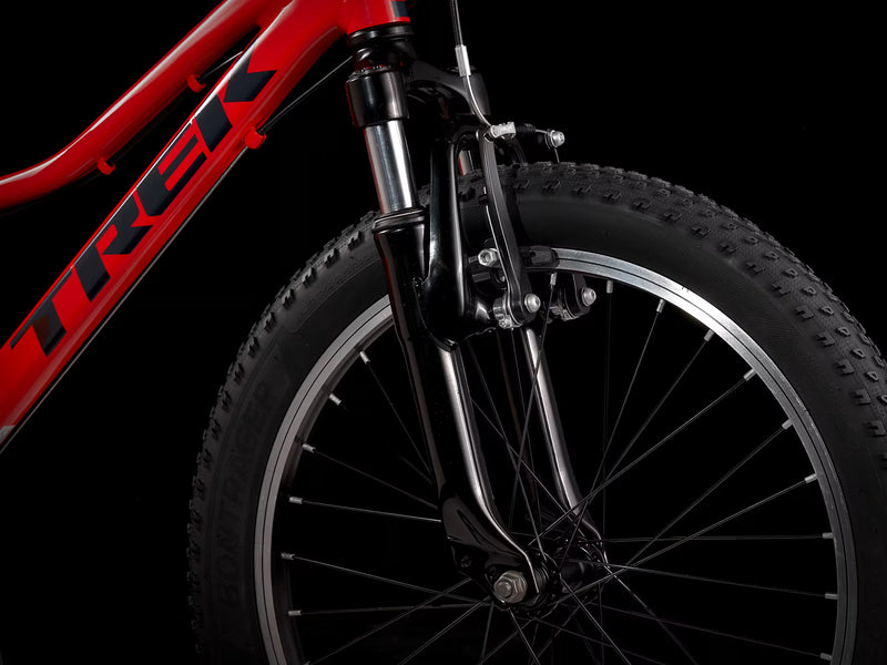 Close-up of a red Trek bicycle wheel on a black background