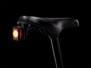 Bicycle seat with a red light on a black background