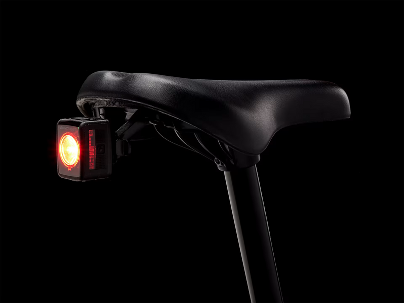 Bicycle seat with a red light on a black background
