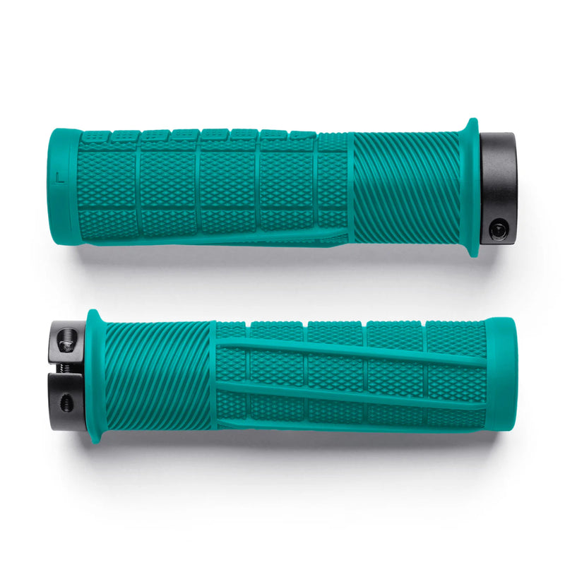 Two teal bicycle handlebar grips on a white background