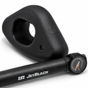 Product shot of one oval JetBlack Freedom Rocker Foot with the pump placed in front on a white background.