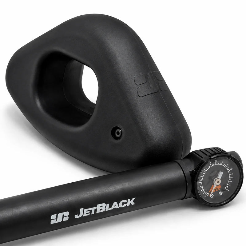 Product shot of one oval JetBlack Freedom Rocker Foot with the pump placed in front on a white background.