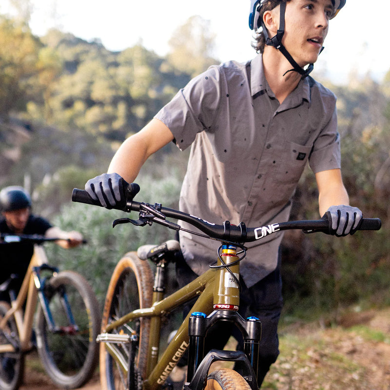 Person riding a bicycle in a forested area