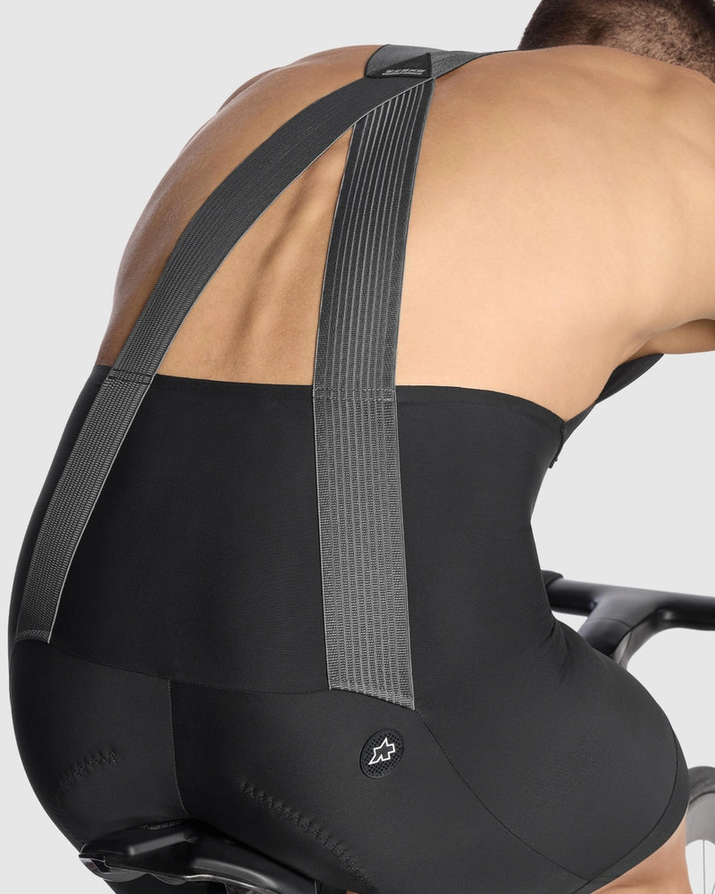 Person wearing a black back brace against a white background