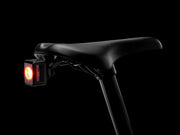 Bicycle seat with a red light on a black background