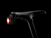 Bicycle seat with a red light on a black background