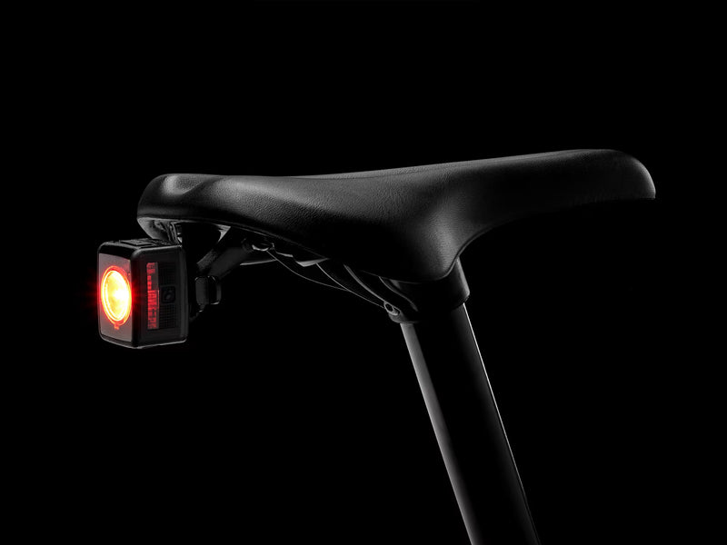 Bicycle seat with a red light on a black background