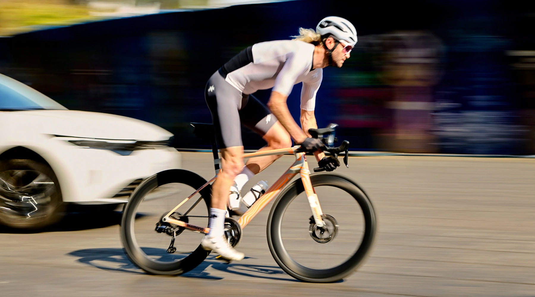 Person riding a bicycle on a road with a blurred background
