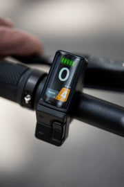 Digital display on a bike handlebar showing battery level and other information.