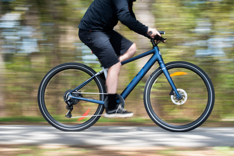 lifestyle image of man on bike with blurry backgrouund