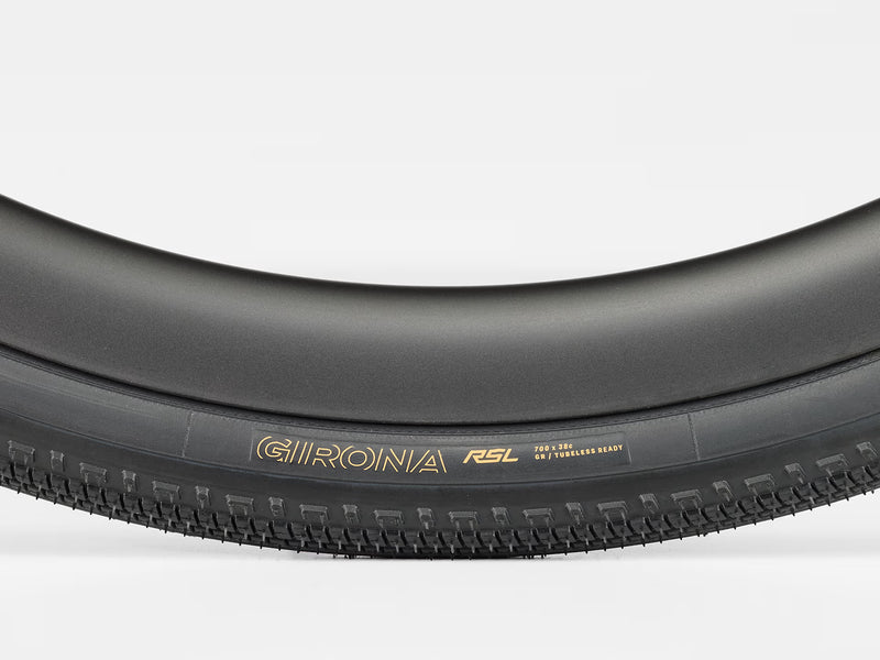Close-up of a black bicycle tire with 'Girona' branding on a white background