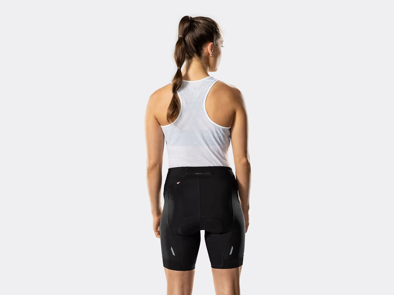 Bontrager Anara women's black cycling shorts rear view on model, showcasing the high-rise waistband, Profila rear panel, reflective leg details, supportive fit, and performance cycling-specific construction.