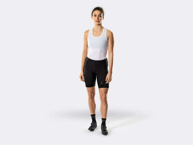 Bontrager Anara women's black cycling shorts full-length view on model, featuring a flattering fitted silhouette, wide waistband, ergonomic panel construction, and Bontrager branding for road and fitness cycling.