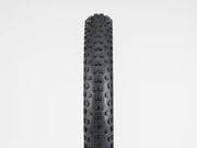 Black tire with tread pattern on a white background