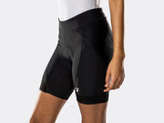 Side profile of the black Bontrager Meraj Women's Cycling Short on a female model, showcasing the perforated mesh side panel, articulated fit, detailed stitching and white Bontrager logo on the left thigh.