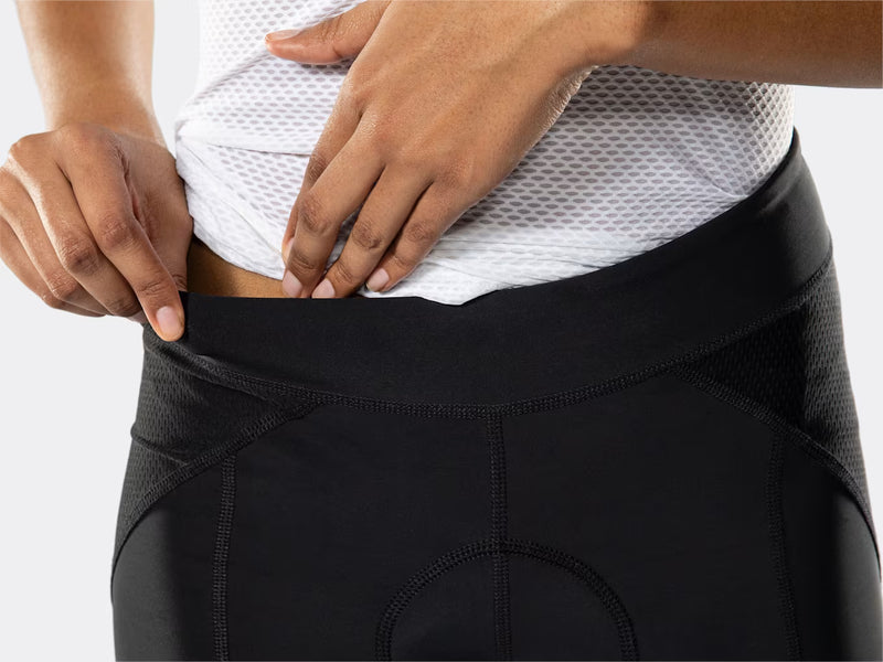 Close-up of the black Bontrager Meraj Women's Cycling Short waistband, highlighting the wide supportive waistband, stretch fabric, contoured panel construction, ventilated mesh side panels and performance cycling fit.