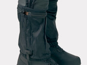 Bontrager OMW softshell pant in black worn, close-up of lower legs with internal gaiter and snow boots