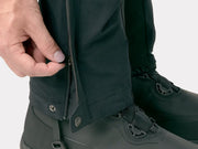 Bontrager OMW softshell pant in black worn, close-up of zippered leg opening over a boot