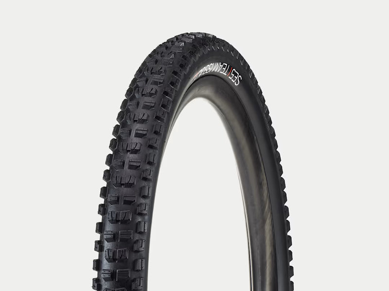 Black tire with tread pattern on a white background