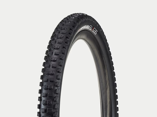 Black tire with tread pattern on a white background