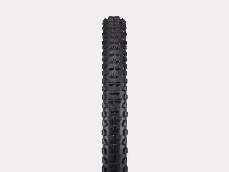 Black tire with tread pattern on a light gray background