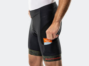 Close-up of the side pocket on the black Bontrager Troslo inForm Cycling Liner Short with a snack going in, mesh vent panel and orange logo on the camo cuff