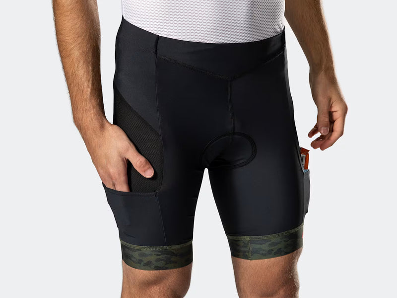Front close-up of the black Bontrager Troslo inForm Cycling Liner Short with V-shaped waistband, snack in the pocket and green camo cuff