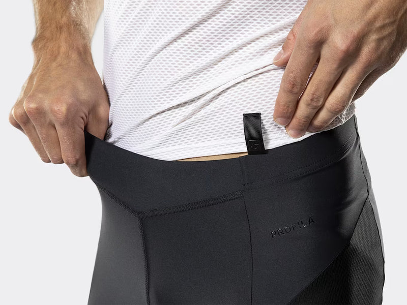Close-up of the waistband on the black Bontrager Troslo inForm Cycling Liner Short being pulled out to show the snug stretch fit, with stitching and mesh panel