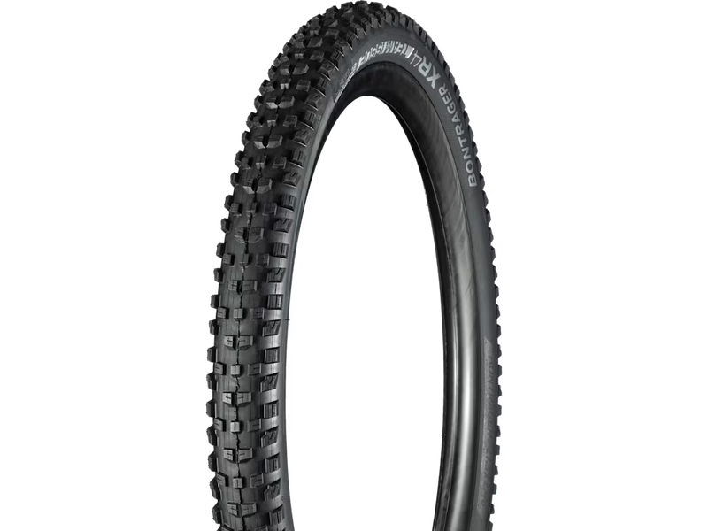 Black bicycle tire with tread pattern on a white background